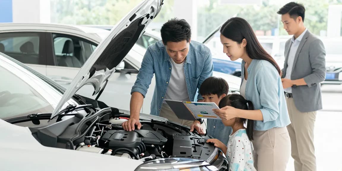 Family engaging in a car history check UK for a second-hand vehicle at a dealership, ensuring transparency in their purchase.
